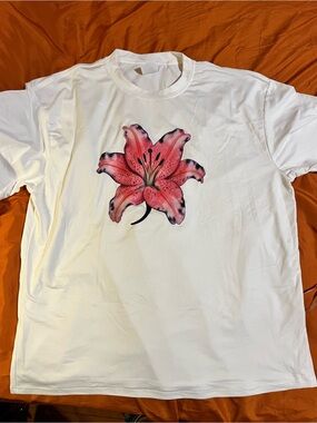 Woman white t-shirt with a bold pink & black watercolor-style lily graphic